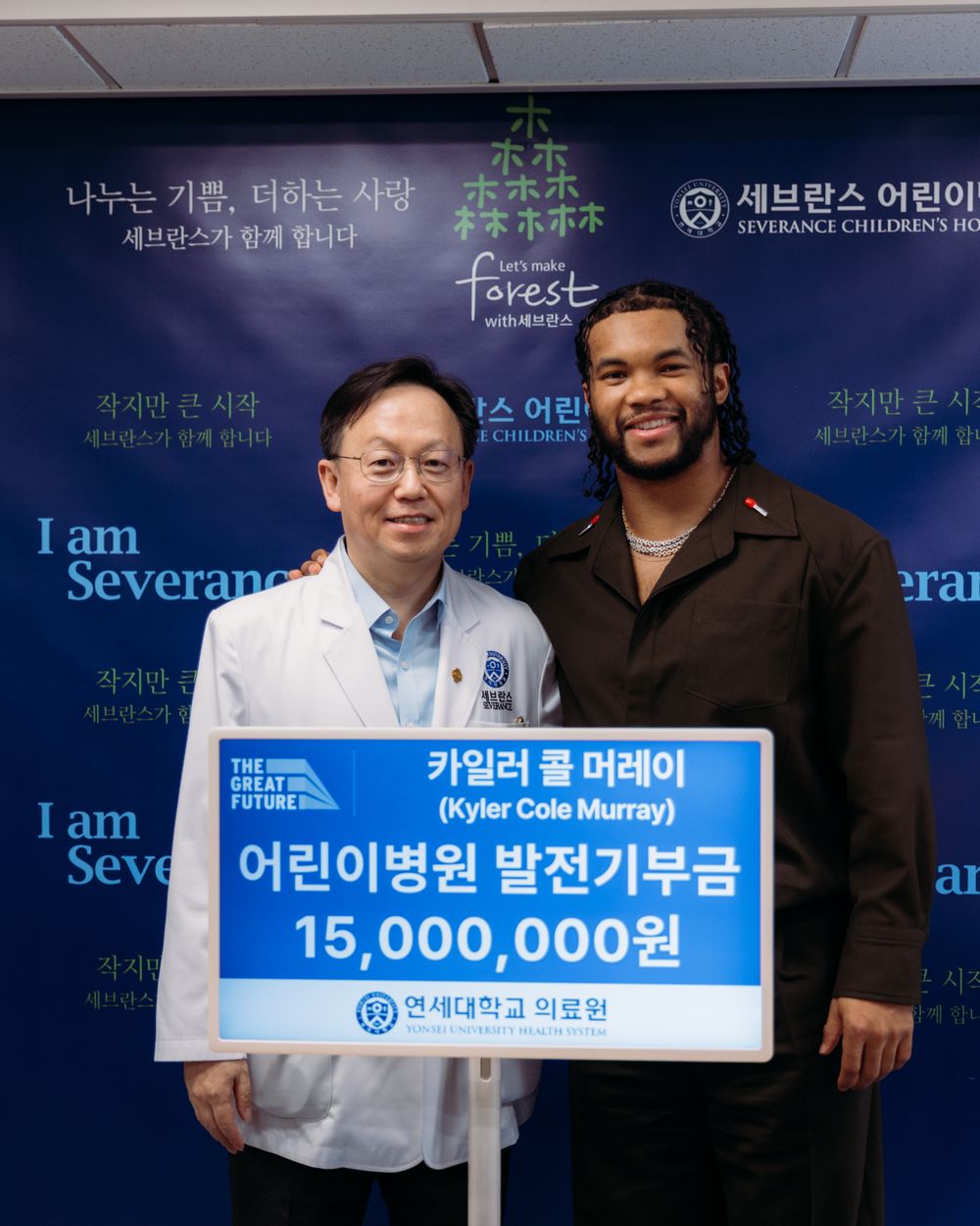 Kyler Murray with a Severance Children's Hospital physician presenting the Foundation's donation